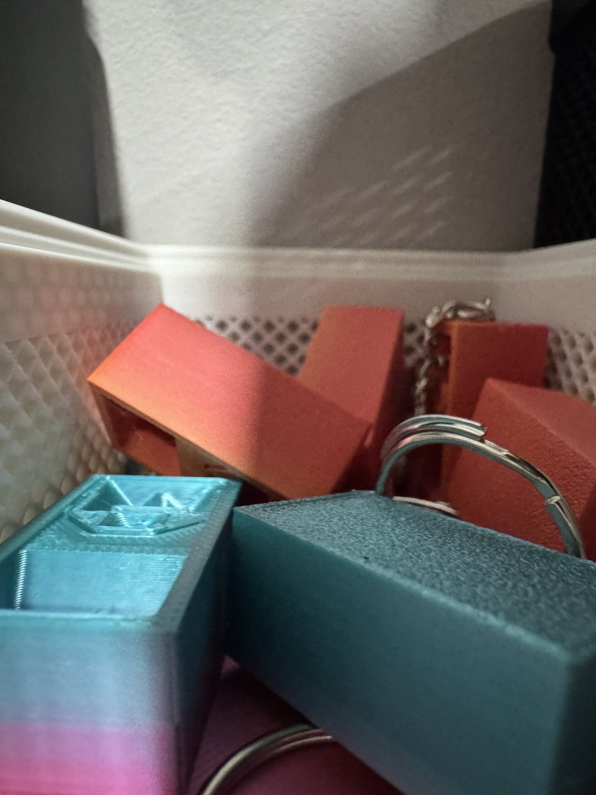 Colour-shifting speaker keychains with the rings fitted.